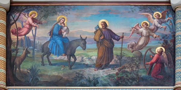 VIENNA, AUSTRIA - FEBRUARY 17, 2014: Flight of holy family to Egypt fresco by Josef Kastner from 1906 - 1911 in Carmelites church in Dobling. — Stock Photo, Image