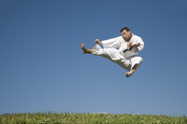 Karate kick of man