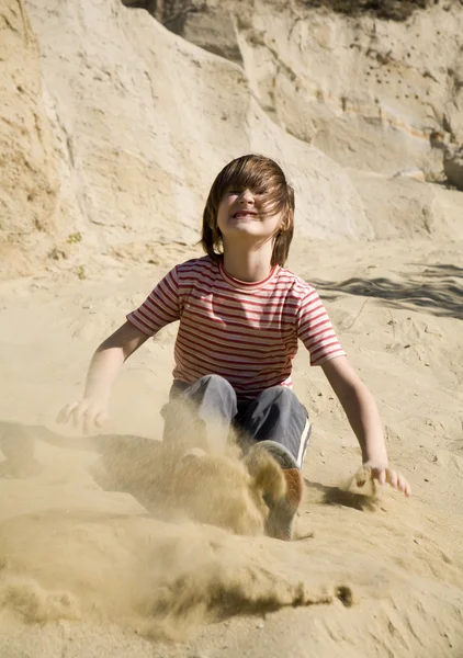 Jump of little girl in the sand — Stock Photo, Image