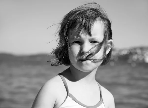 Portrét holčička na pláži ve větru — Stock fotografie