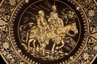 TOLEDO - MARCH 8: Detail of typical damascening plate with the Don Quixote and Sancho Panza. Traditional handicraft with metal on March 8, 2013 in Toledo, Spain. clipart