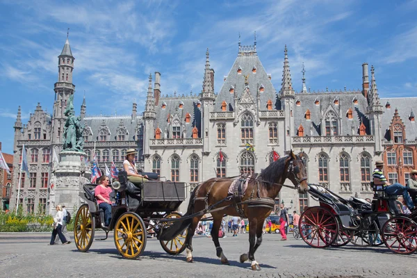 Brugge, Belgie - 13 červen 2014: přeprava na náměstí grote markt a provinciaal hof, budova v pozadí. — Stock fotografie