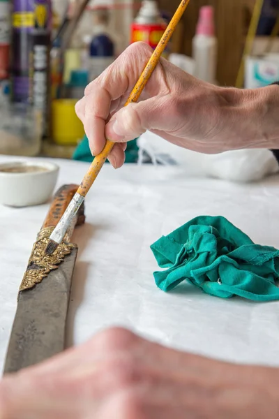 Restoration of old Turkish sword - detail of hand at work — Stock Photo, Image