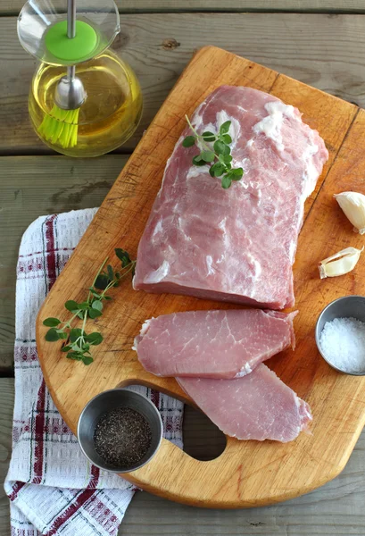 Fresh pork loin chops on the wooden cutting board — Stock Photo, Image