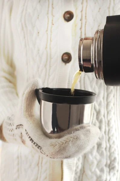 Mani in guanti lavorati a maglia con una tazza di tè al limone — Foto Stock