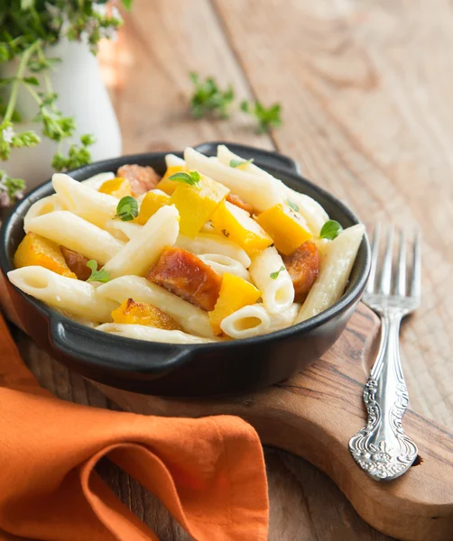 Pasta with cream sauce, italian sausage and pumpkin — Stock Photo, Image