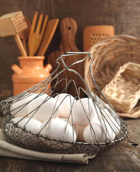 Eieren in de mand en keuken kookgerei, afgezwakt — Stockfoto