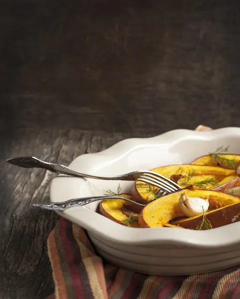 Baked pumpkin slices with garlic. Toned image — Stock Photo, Image