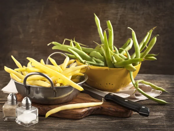 Fresh Green and Yellow Beans on wooden table — Stock Photo, Image