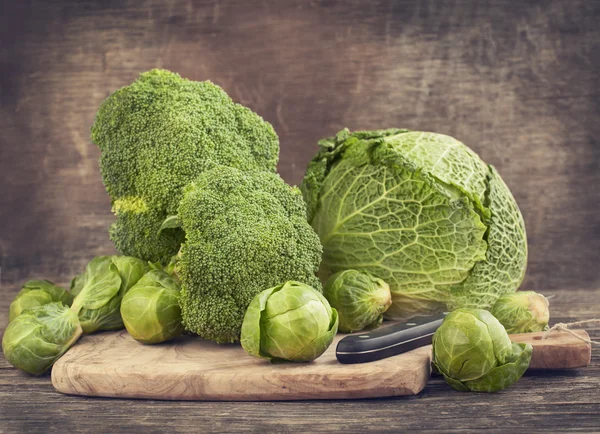 Still life with assortment cabbages on wooden background — Stock Photo, Image