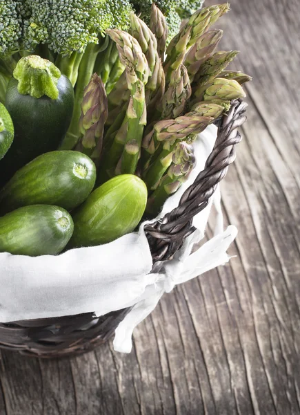 Verdure verdi fresche in cesto su uno sfondo di legno . — Foto Stock