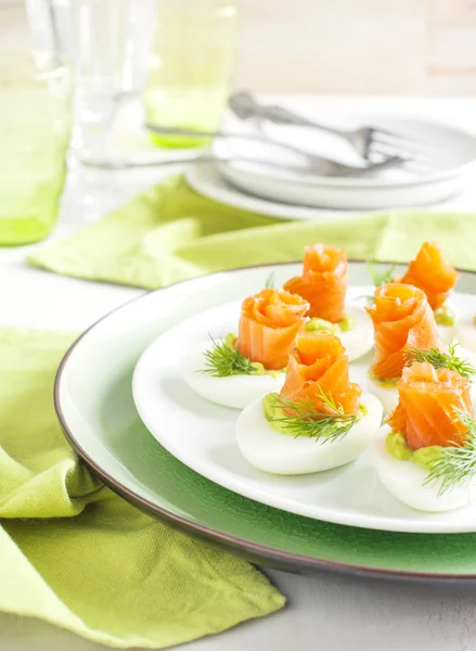 Stuffed eggs. Hard boiled eggs with avocado filling and smoked salmon — Stock Photo, Image