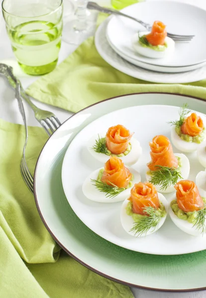 Stuffed eggs. Hard boiled eggs with avocado filling and smoked salmon — Stock Photo, Image