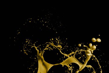 Yellow paint splashes, isolated on black background