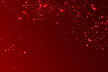 Kırmızı arkaplanda kırmızı toz patlaması.