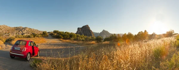 Beautiful panoramic photo of road through the amazing rocky mountain landscape of Sierra de Grazalema Natural Park at sunset. Rocks and pine trees. Blue sky. Andalusia. — Stock Photo, Image
