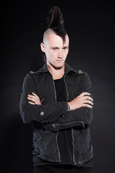 Punk man with mohawk haircut. Expressive face. Grey jacket. Isolated on black background. Studio shot. — Stock Photo, Image