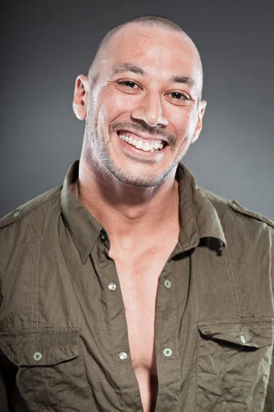 Muscled tough guy wearing green army shirt. Good looking man. Isolated on grey background. Studio shot. Healthy. Fitness. — Stock Photo, Image