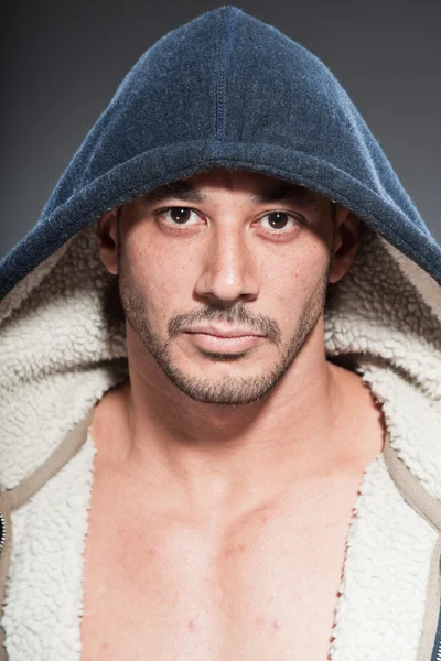 Muskulöser Fitness-Mann. Cooles Aussehen. Harter Kerl. Braune Augen. Glatze. trug ein blaues Kapuzenshirt. gebräunte Haut. Studioaufnahme isoliert auf grauem Hintergrund. — Stockfoto