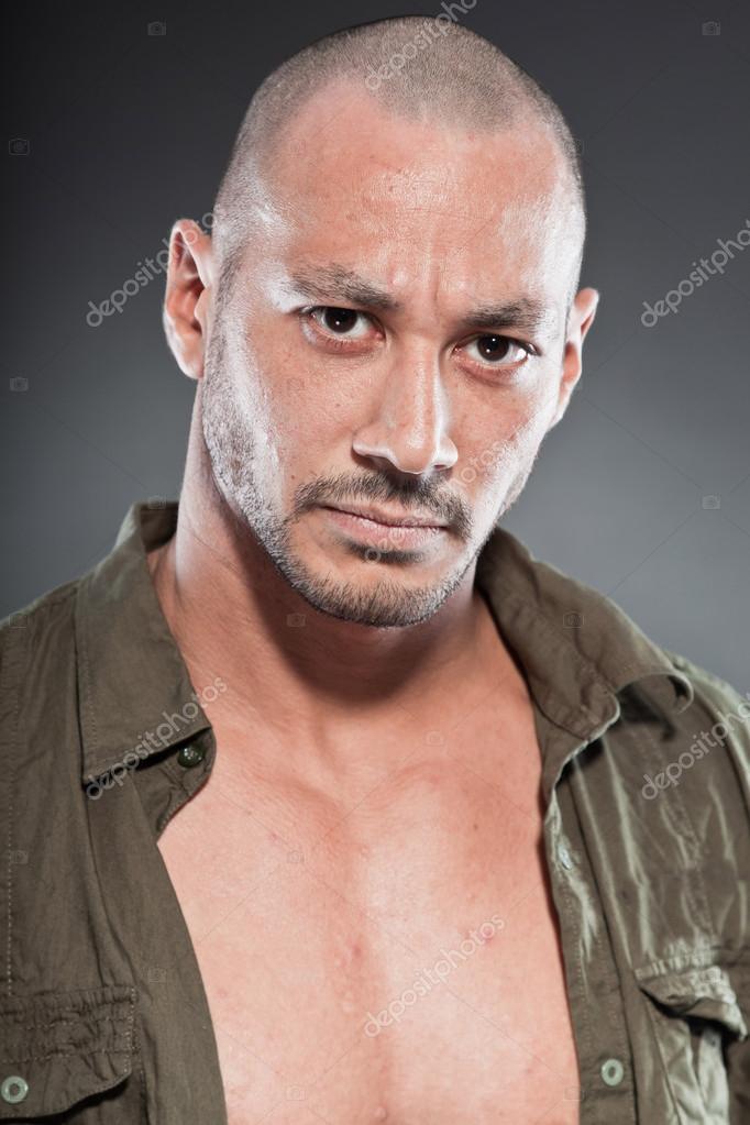 Muscled tough guy wearing green army shirt. Good looking man. Isolated on  grey background. Studio shot. Healthy. Fitness. — Photo