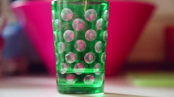 Green glass filled with water — Stock Video
