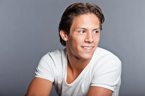 Teenage boy with brown hair and eyes. Wearing white t-shirt. Good looking. Casual wear. Expressions. Studio closeup portrait isolated on grey background. — Stock Photo, Image