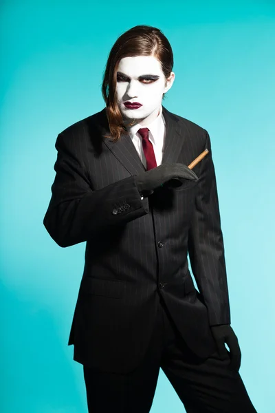 Gothic vampire looking business man wearing black striped suit and dark red tie. — Stock Photo, Image