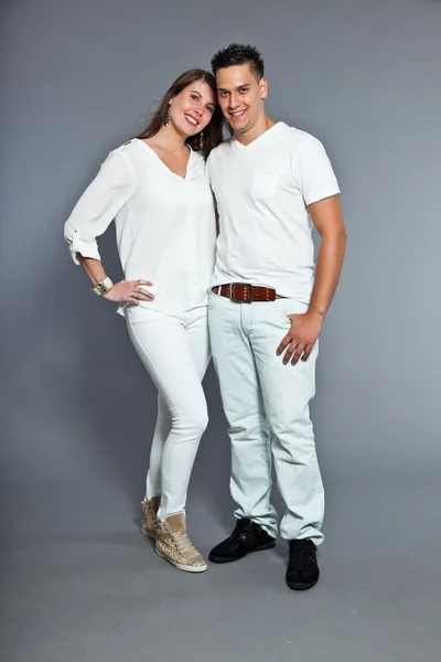 Diverse young happy couple together. Dressed in white. Stock Picture