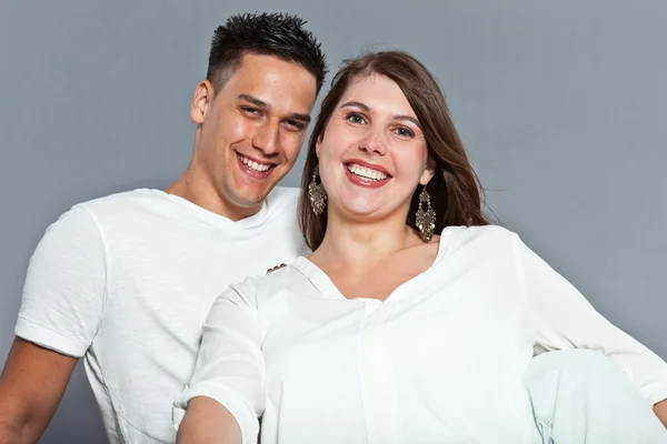 Diverse young happy couple together. Dressed in white. Stock Photo