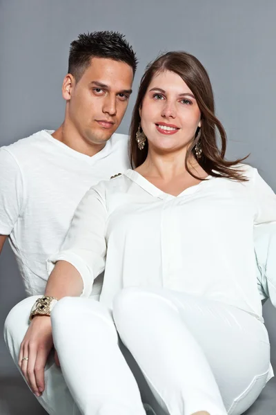 Diverse young happy couple together. Dressed in white. Royalty Free Stock Images