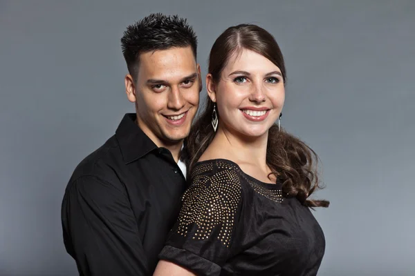 Diverse young couple together. Dressed in black. Stock Image