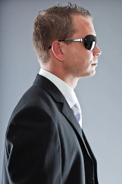 Happy young business man with short hair wearing dark suit with white shirt and purple tie. — Stock Photo, Image