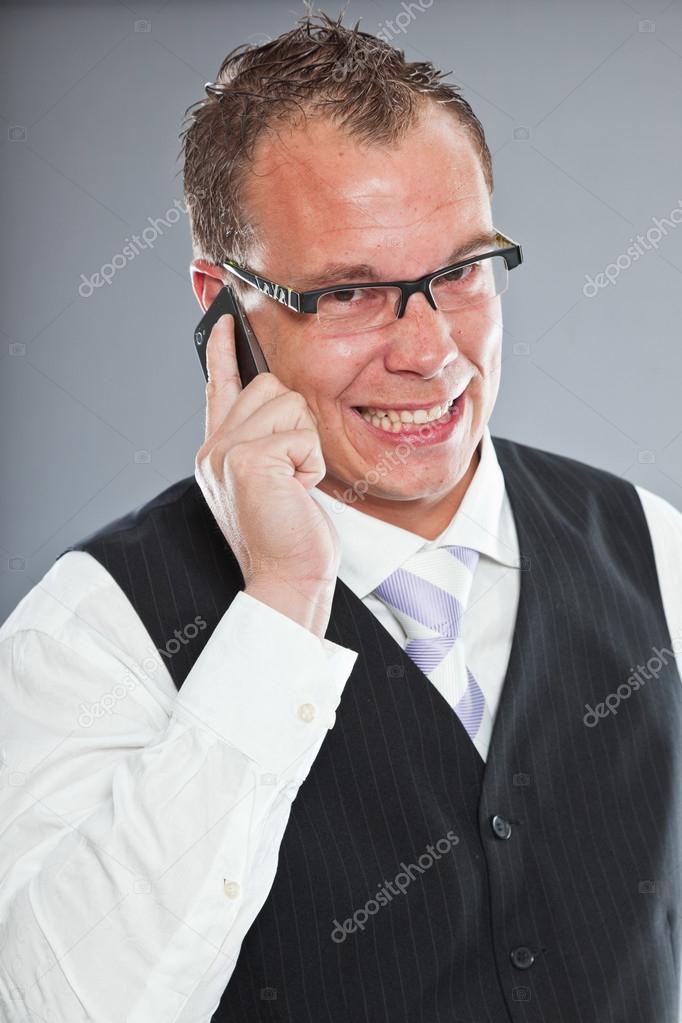 Angry Young Business Man Calling With Mobile Phone With