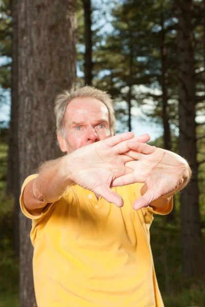 Senior man stretching his arms. — Stock Photo, Image