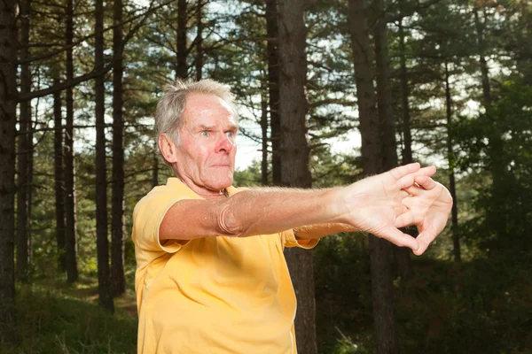 Senior man stretching his arms. — Stock Photo, Image