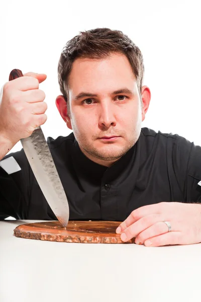 Jonge mannelijke kok met zwarte koks jas. — Stockfoto