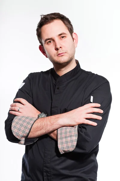 Young male cook with black cooks jacket. — Stock Photo, Image