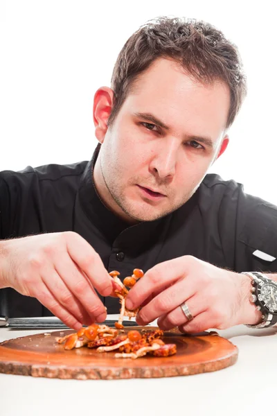 Young male cook with black cooks jacket isolated on white. — Stock Photo, Image