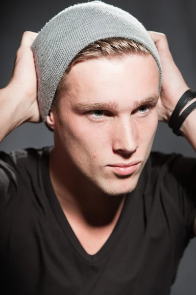 Fashion studio portrait of handsome young man against grey background. — Stock Photo, Image