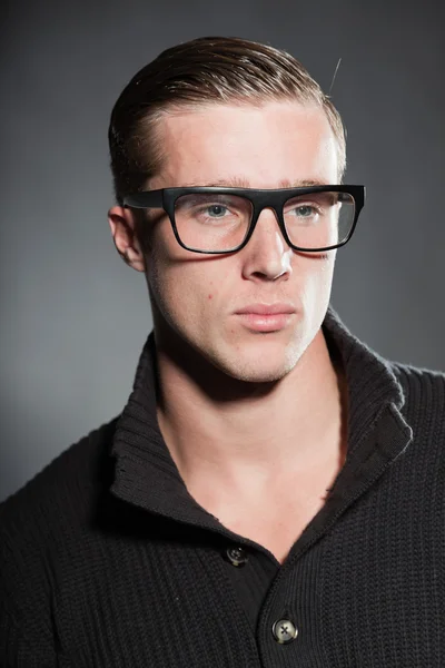 Fashion studio portrait of handsome young man against grey background. — Stock Photo, Image