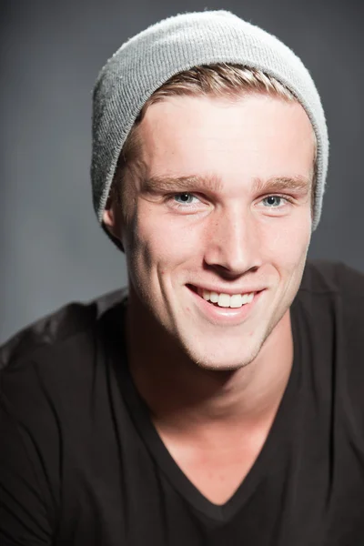 Fashion studio portrait of handsome young man against grey background. — Stock Photo, Image