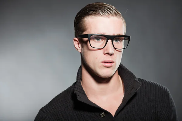 Fashion studio portrait of handsome young man against grey background. — Stock Photo, Image