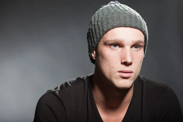 Fashion studio portrait of handsome young man against grey background. — Stock Photo, Image