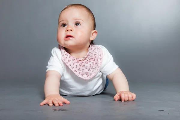 Şirin Bebek kız gri bir arka plana dayanır. — Stok fotoğraf