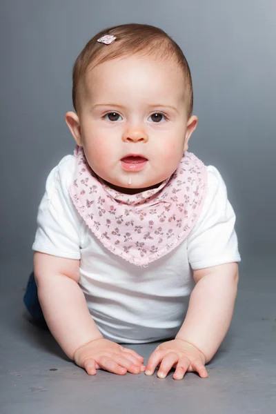 Cute baby girl against grey background. — Stock Photo, Image