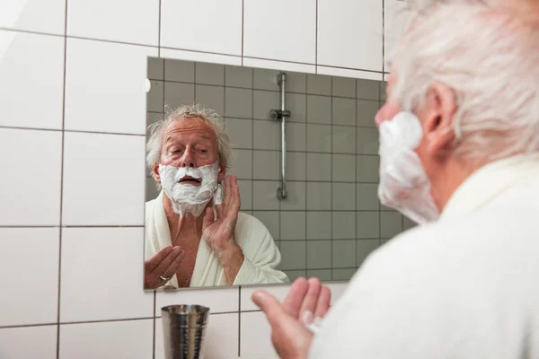 Senior man shaving his beard. — Stock Photo, Image