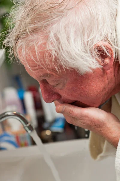 Senior man washing his face. — Stock Photo, Image