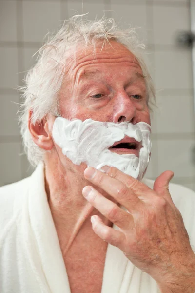 Senior man shaving his beard. — Stock Photo, Image