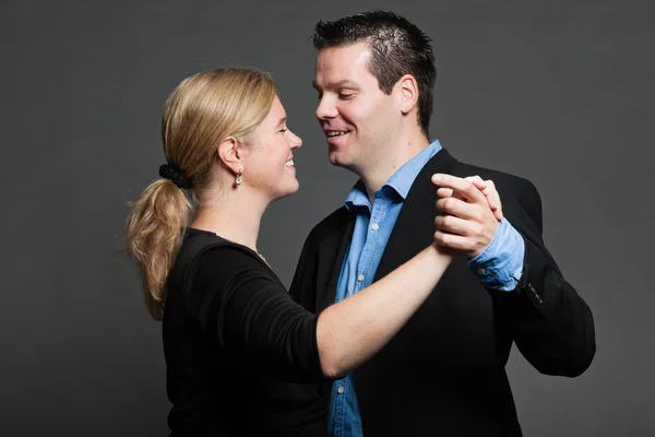 Young couple. Studio shot against grey. — Stock Photo, Image