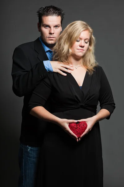 Young couple. Studio shot against grey. — Stock Photo, Image